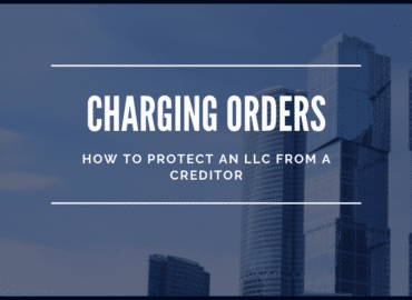 Promotional banner reading "Charging Orders - How to Protect LLC from a Creditor," with a background of skyscrapers under a clear blue sky.