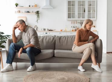 Unhappy Senior Couple Not Speaking After Quarrel Thinking About Divroce Sitting Back-To-Back, Experiencing Marital Crisis In Relationship At Home. Spouses Having Comunication Issues