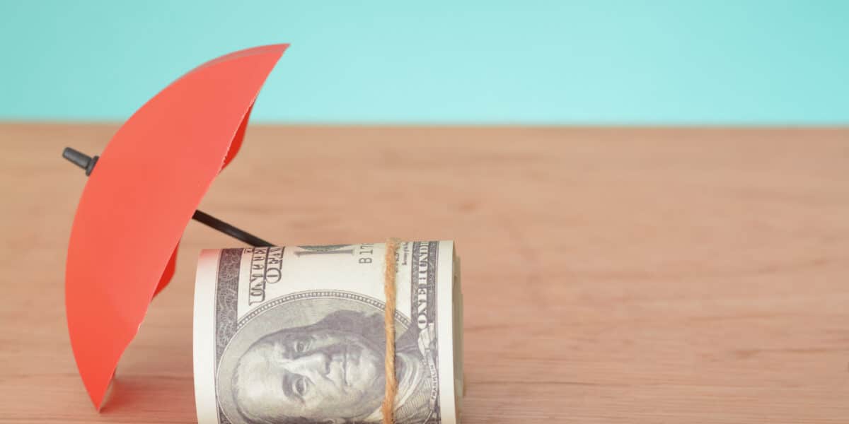 Red umbrella and money banknotes